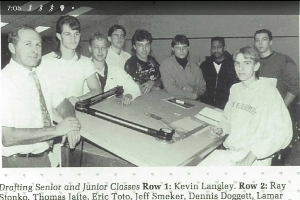 Black and white photo of a high school drafting class featuring Jeff Smeker and classmates gathered around a drafting table, circa early 1990s.