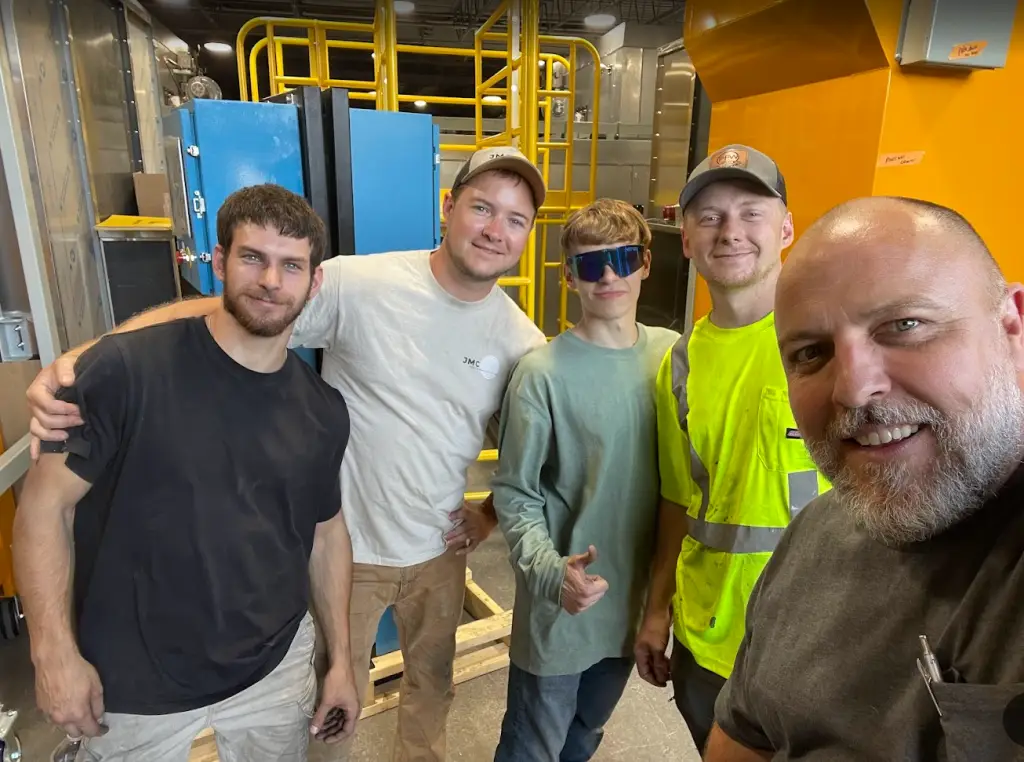 Group selfie of the installation team wrapping up a finishing system project in New York.