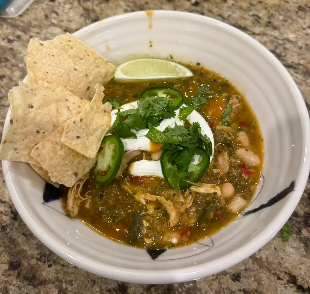 Green chicken chili with roasted tomatillos, guajillo pepper, white beans, and fresh cilantro