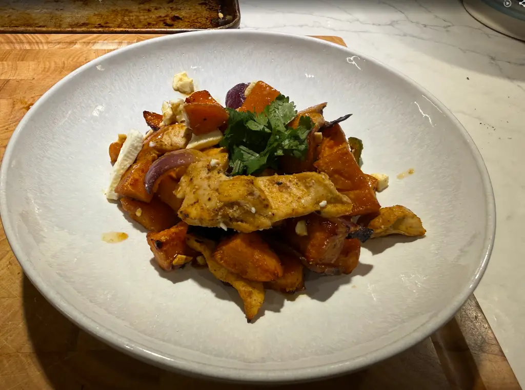 Sheet-pan hot honey chicken with roasted sweet potatoes, jalapeños, red onion, crumbled feta, and fresh cilantro.