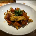 Sheet-pan hot honey chicken with roasted sweet potatoes, jalapeños, red onion, crumbled feta, and fresh cilantro.