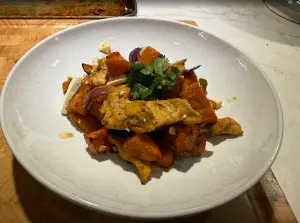 Sheet-pan hot honey chicken with roasted sweet potatoes, jalapeños, red onion, crumbled feta, and fresh cilantro.
