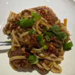 Spicy crockpot Mongolian beef and noodles with onions and green onions