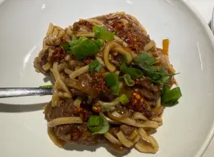 Spicy crockpot Mongolian beef and noodles with onions and green onions